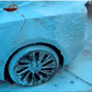 Turquoise blue car wash foam applied to a vehicle during detailing