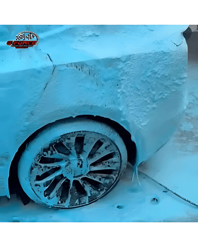Turquoise blue car wash foam applied to a vehicle during detailing